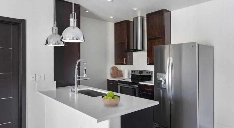 a kitchen with a stainless steel refrigerator