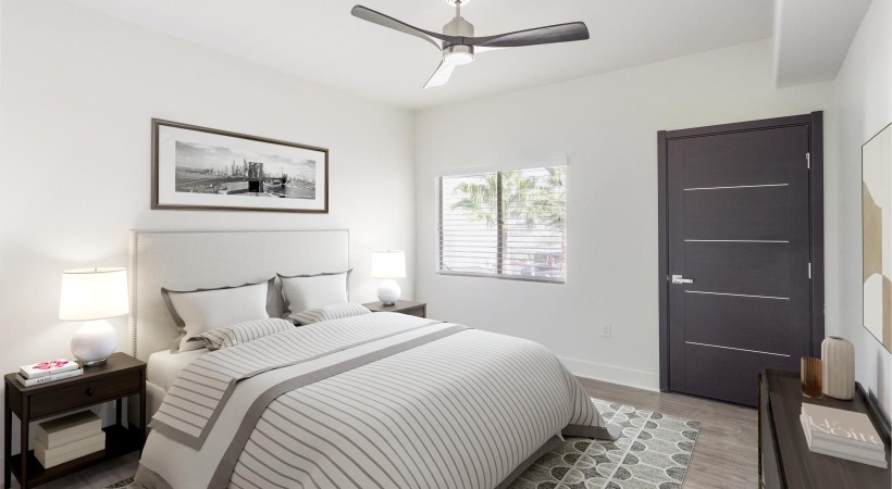 a bedroom with a bed and a fan