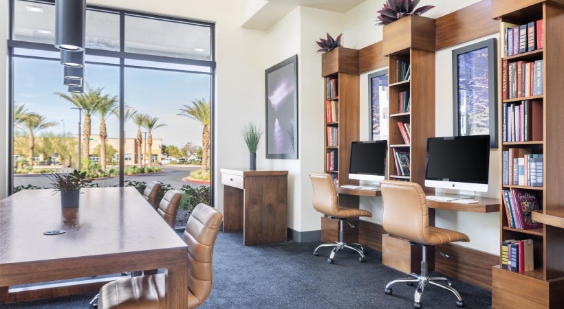a room with a desk and bookshelves